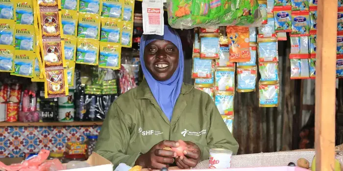 Somali woman standing proudly in her grocery stall
